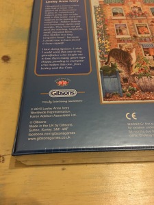 Gibsons Peeping Tom cat themed jigsaw puzzles, 500 pieces. Made in the UK and are labelled as such. Photograph by author. Rear of box view, close up of country of origin label.
